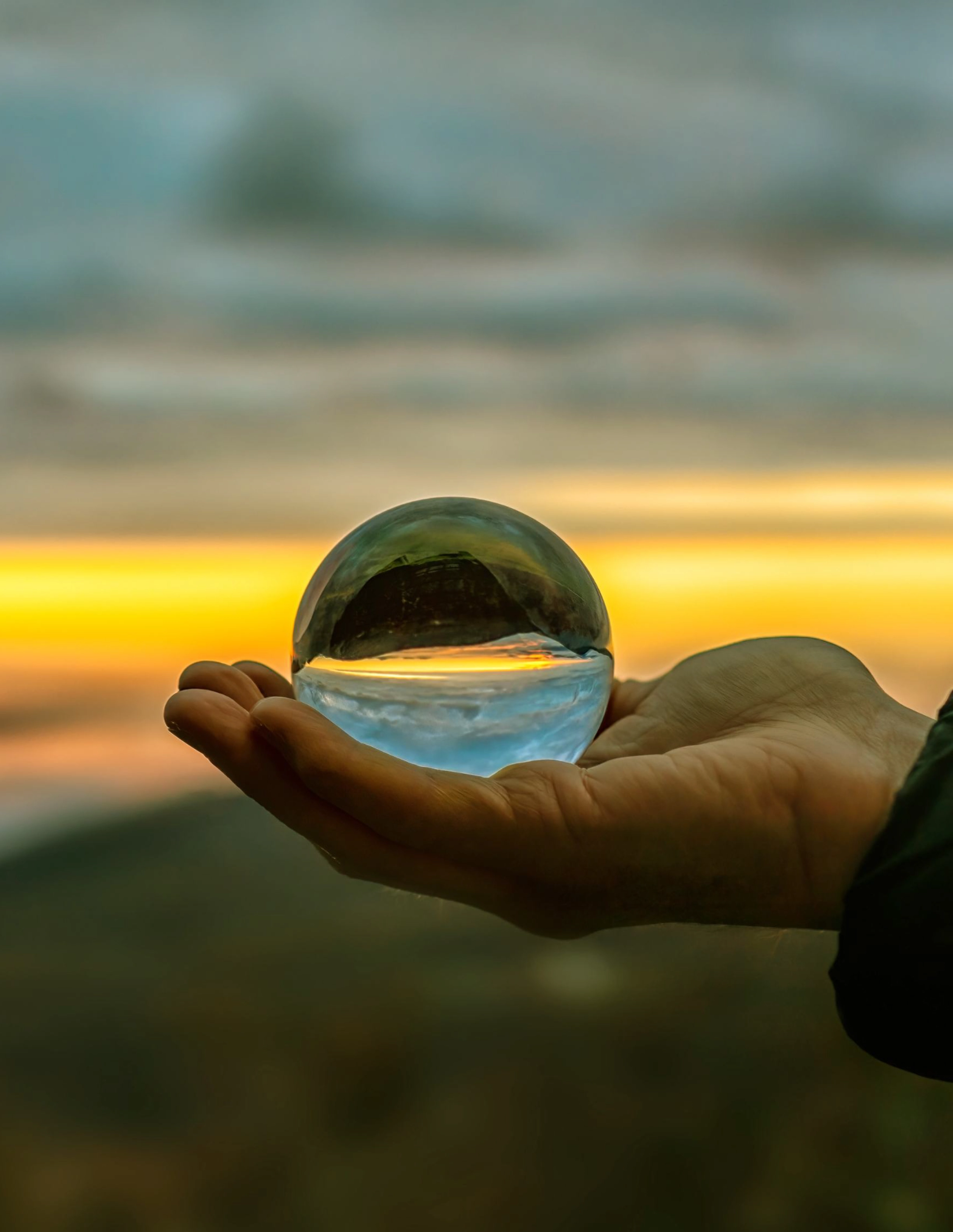 Close-up shot of a hand holding a crystal ball